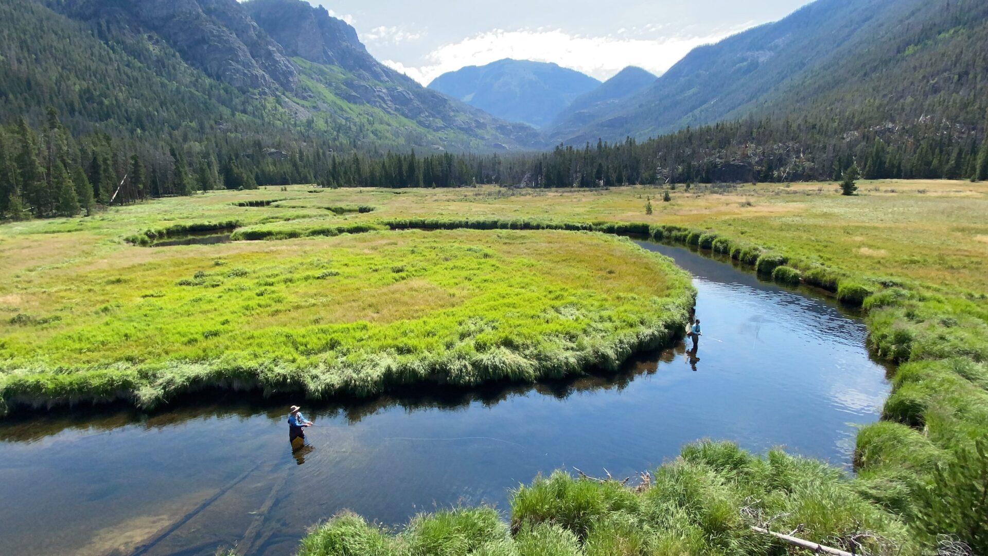 Fly fishing a winding creek through a Rocky Mountain meadow