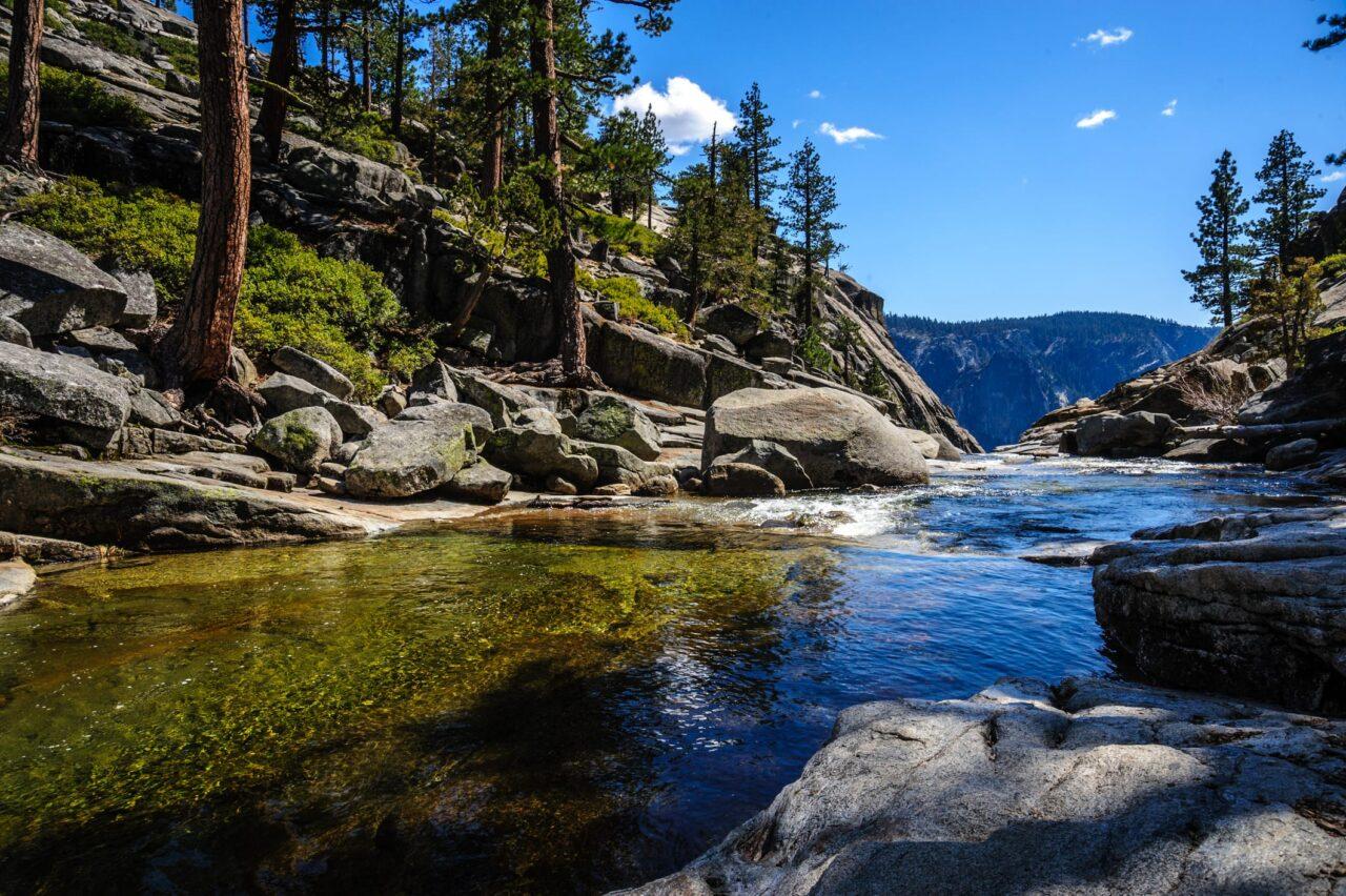 Mountain stream leading to a hidden waterfall